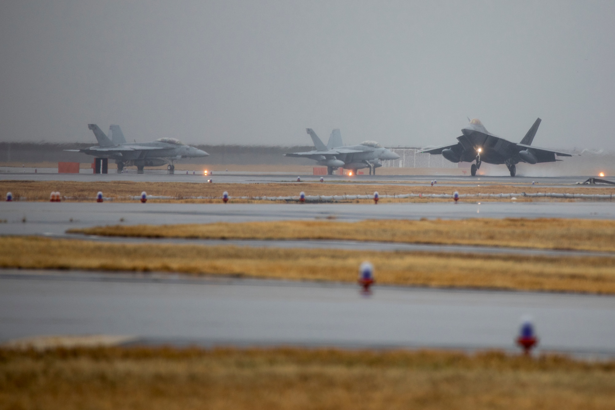 A U.S. Air Force F-22 Raptor with the 199th Fighter Squadron, lands at Marine Corps Air Station Iwakuni Japan, March 12, 2021. Airmen with the 199th Fighter Squadron and the 19th Fighter Squadron, based out of Joint Base Pearl Harbor-Hickam, Hawaii, deployed to MCAS Iwakuni to conduct local area training with U.S. Marine Corps units. This training event is designed to support a free and open Indo-Pacific by providing global reach and agility throughout the area. (U.S. Marine Corps photo by Lance Cpl. Tyler Harmon)