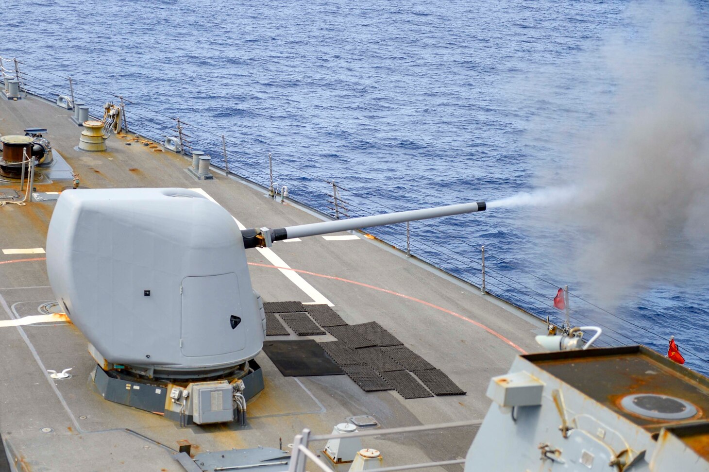 INDIAN OCEAN (March 12, 2021) The Arleigh Burke-class guided-missile destroyer USS Russell (DDG 59) fires its Mark 45 5-inch gun during a surface target exercise March 12, 2021. Russell, part of the Theodore Roosevelt Carrier Strike Group, is on a scheduled deployment to the U.S. 7th Fleet area of operations. As the U.S. Navy’s largest forward-deployed fleet, 7th Fleet routinely operates and interacts with 35 maritime nations while conducting missions to preserve and protect a free and open Indo-Pacific. (U.S. Navy photo by Mass Communication Specialist 3rd Class Wade Costin)