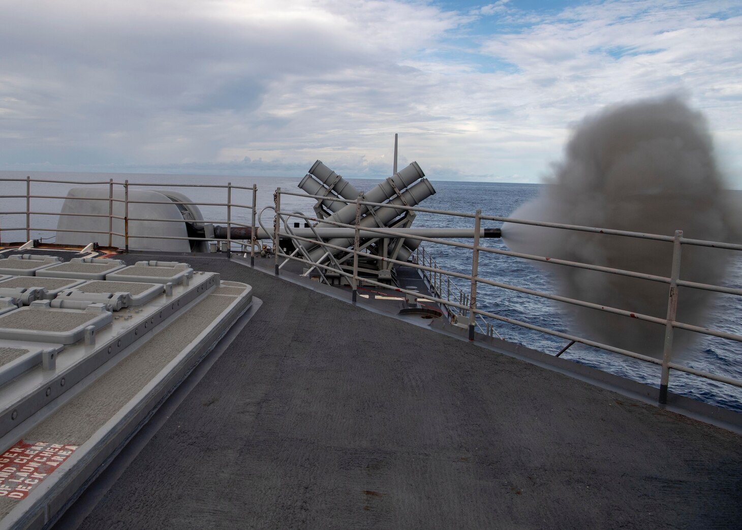 INDIAN OCEAN (March 12, 2021) The Ticonderoga-class guidided-missile cruiser USS Bunker Hill (CG 52) fires its Mark 45 5-inch gun during a surface target exercise March 12, 2021. Bunker Hill, part of the Theodore Roosevelt Carrier Strike Group, is on a scheduled deployment to the U.S. 7th Fleet area of operations. As the U.S. Navy’s largest forward-deployed fleet, 7th Fleet routinely operates and interacts with 35 maritime nations while conducting missions to preserve and protect a free and open Indo-Pacific. (U.S. Navy photo by Mass Communication Specialist 2nd Class Brandie Nuzzi)
