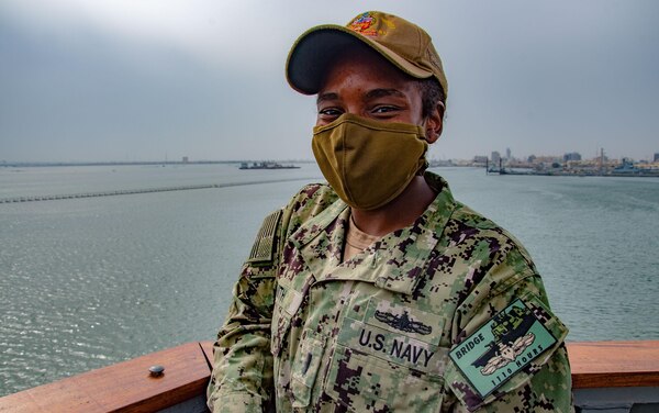 210218-N-PS962-1092 PORT OF BAHRAIN (Feb. 18, 2021) - Ltjg. Blake Smith, Strike Officer aboard the guided-missile destroyer USS Winston S. Churchill (DDG 81), receives a commemorative patch for completing over 1,110 hours of bridge watchstanding while underway in accordance with the Mariners Skills log book in Port Bahrain, Feb. 18. Winston S. Churchill is deployed to the U.S. 6th Fleet area of operations in support of regional allies and partners and U.S. national security interests in Europe and Africa. (U.S. Navy photo by Mass Communication Specialist 3rd Class Louis Thompson Staats IV)