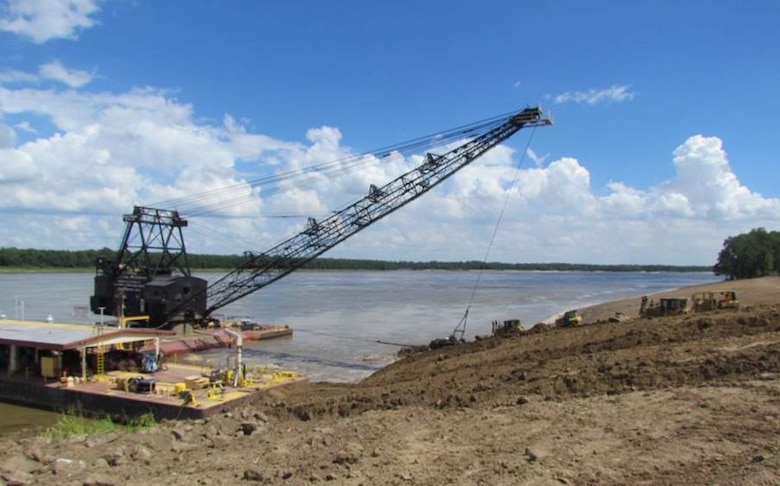 IN THE PHOTO, our current bank grading unit. The equipment used to ‘grade’ the river bank is a vintage 1949 barge mounted Bucyrus-Erie dragline with a 183 foot boom and a 15 cubic yard bucket. Additional earthmoving capacity is provided by a compliment of bulldozers. Channel Improvement Team members discussed the future replacement of this bank grading unit by the Seatrax unit pictured below.