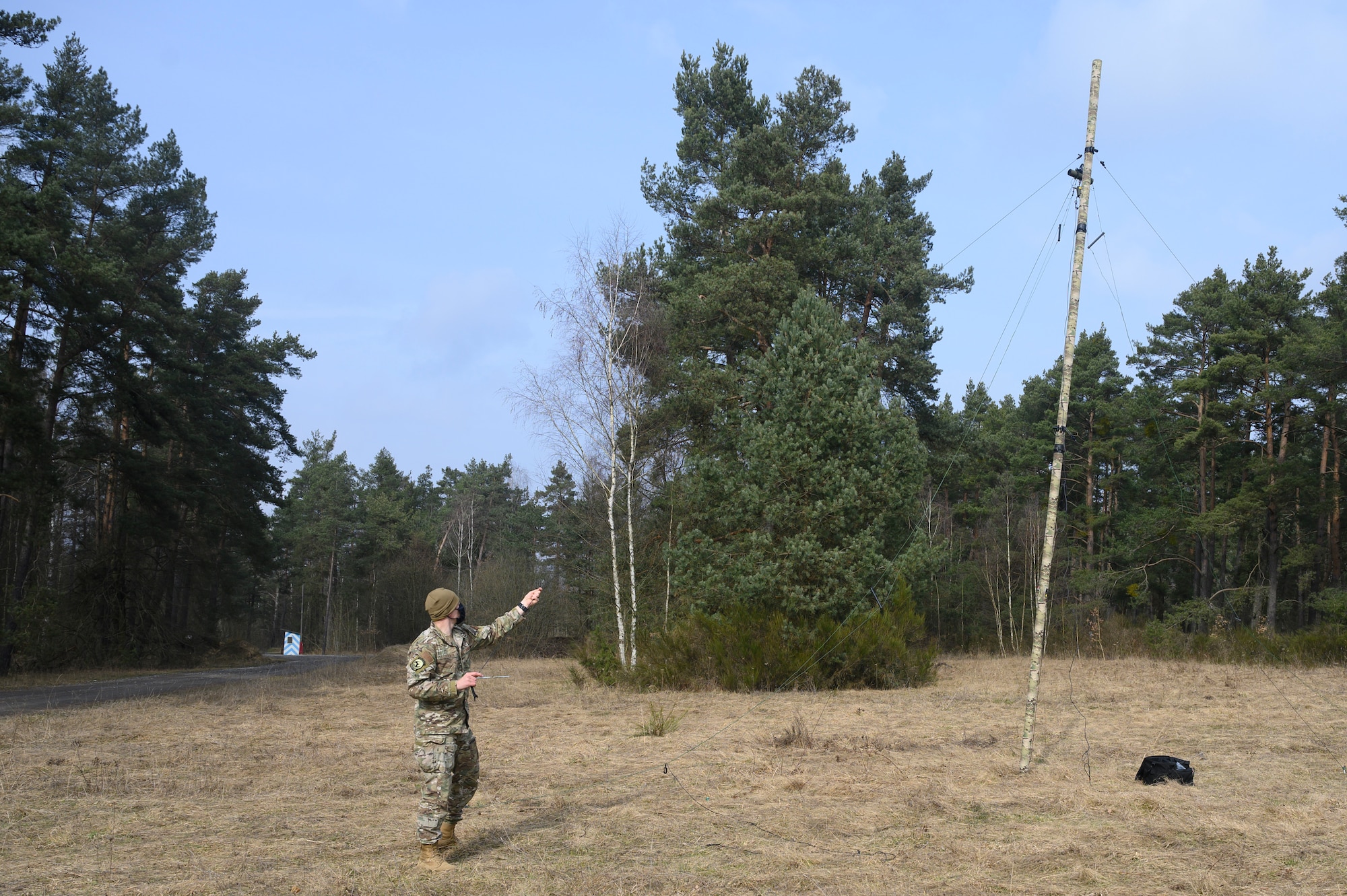 An Airman sets up a high frequency antenna.