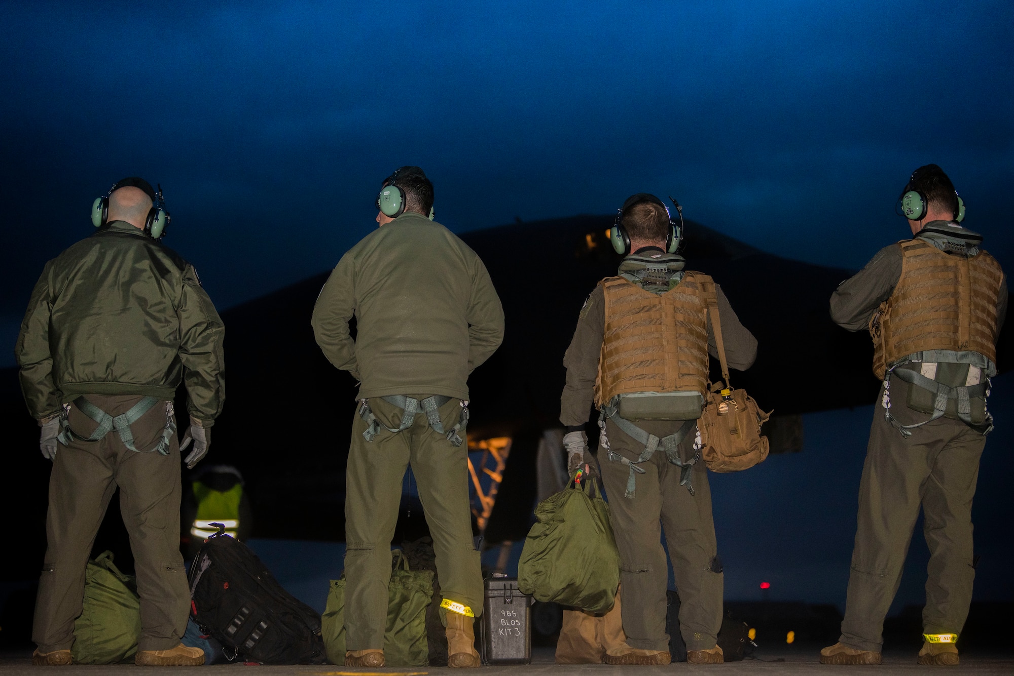 Aircrew assigned to the 9th Expeditionary Bomb Squadron wait to board a B-1B Lancer at Ørland Air Force Station, Norway, March 12, 2021. The B-1 was refuelled using a hot-pit ground refuelling method before taking off to conduct close air support training at the Setermoen range in northern Norway where the aircrew integrated with U.S. Marine and Norwegian Joint Terminal Attack Coordinators. (U.S. Air Force photo by Airman 1st Class Colin Hollowell)