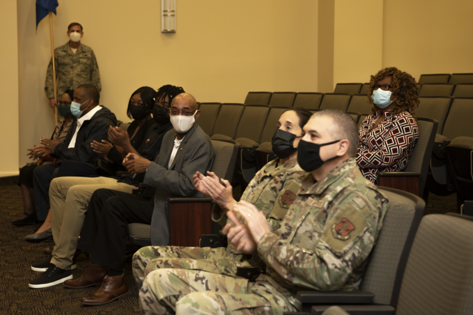 The audience applauds during a change of command ceremony