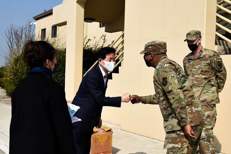 Chairman Kang, Duk-in, Korean and American Gunsan Alliance, greets Chief Master Sgt. Ronnie "Wolf Chief" Woods, , 8th Fighter Wing command chief, at Kunsan Air Base, Republic of Korea, March 10, 2021. The KAGA donated 3,000 copper reusable masks to the Wolf Pack and has been a community partner for the last 40 years. (U.S. Air Force photo by Senior Airman Suzie Plotnikov)
