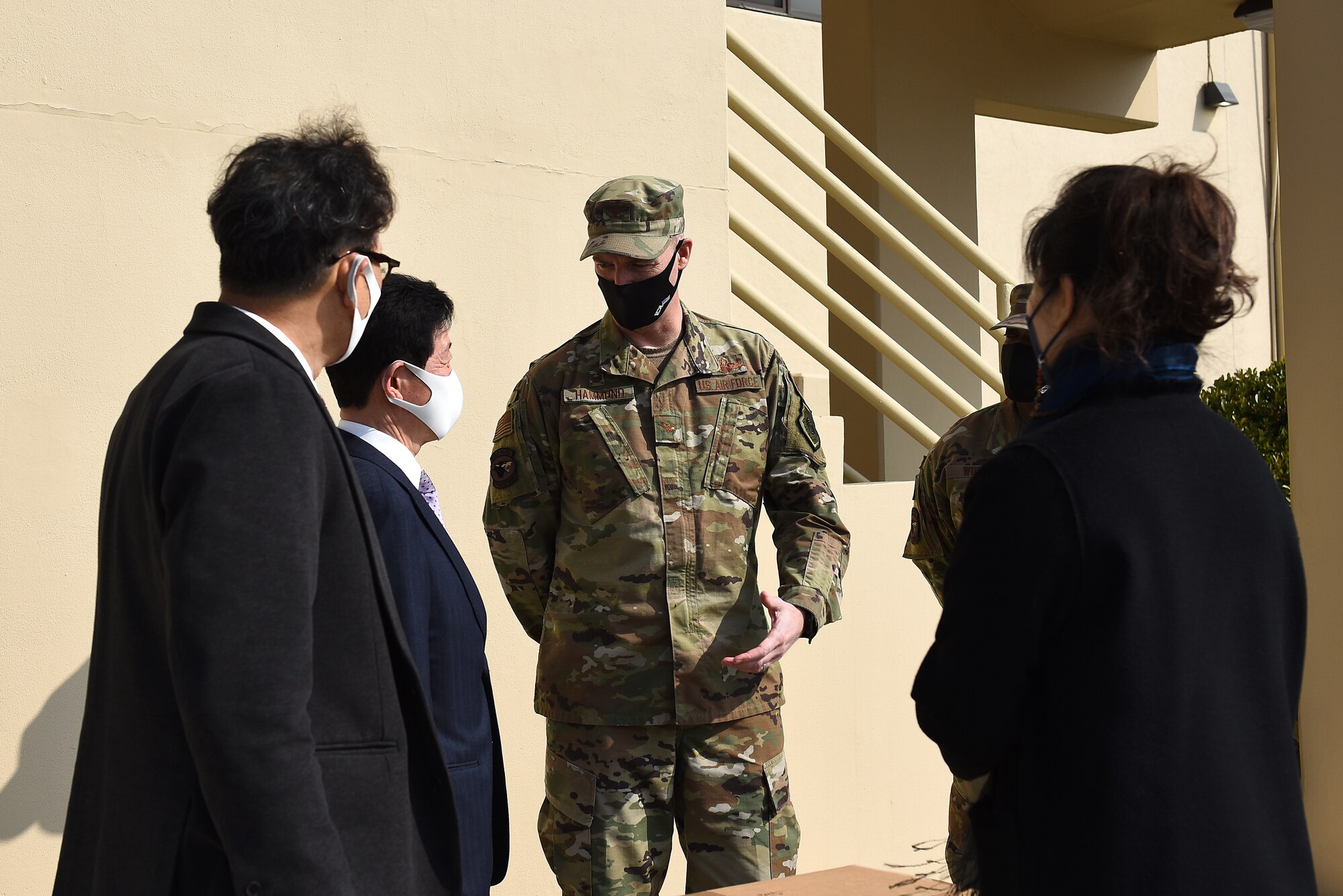Col. Christopher "Wolf" Hammond, 8th Fighter Wing commander, speaks with Chairman Kang, Duk-in, Korean and American Gunsan Alliance, at Kunsan Air Base, Republic of Korea, March 10, 2021. The KAGA donated 3,000 copper reusable masks to the Wolf Pack and has been a community partner for the last 40 years. (U.S. Air Force photo by Senior Airman Suzie Plotnikov)