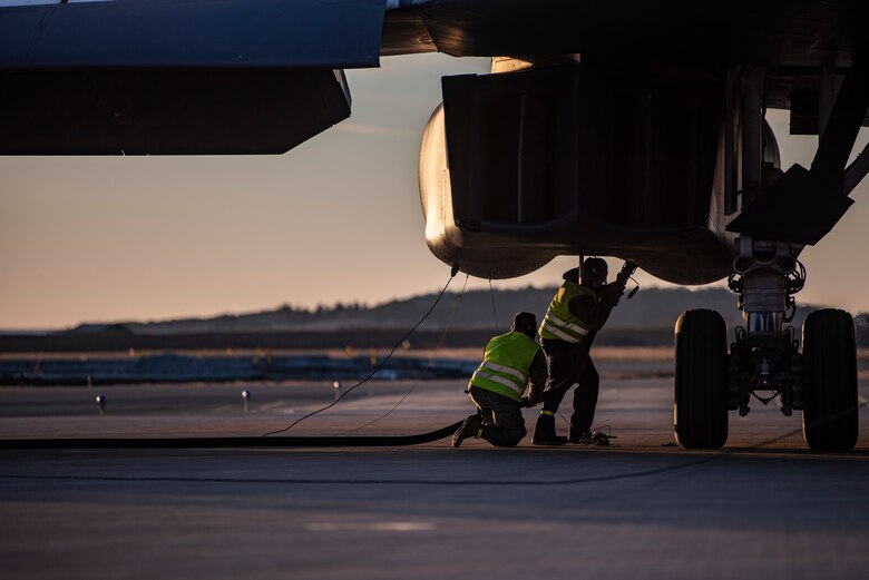 Two crew chiefs assigned to the 9th Expeditionary Bomb Squadron conduct a hot-pit refueling of a B-1B Lancer at Ørland Air Force Station, Norway, March 14, 2021. Hot-pit refuelings allow bombers to be refueled after landing at any airfield capable of supporting the aircraft. (U.S. Air Force photo by Airman 1st Class Colin Hollowell)