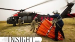 Three UH-60 Black Hawk helicopter crew members conduct training.