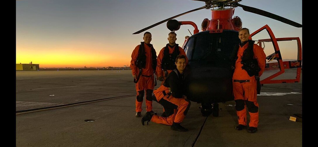 Lt. Mitchell Dow, Lt. Kristin Euchler, Petty Officer 2nd Class Thomas Cheuvront, and Chief Petty Officer Michael VonBormann take a group photograph after successfully medevacing an injured crewman from a commercial cargo ship more than 46 miles west of San Luis Obispo, Feb. 19, 2021.