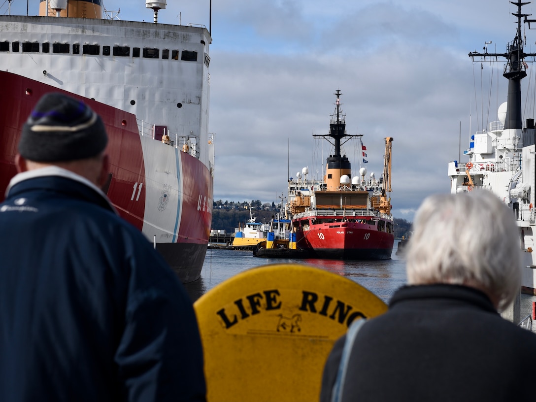 Family members watch as U.S. Coast Guard Cutter Polar Star [WAGB 10] arrives back to its homeport in Seattle on Feb. 20, 2021. The icebreaker’s crew spent a majority of the patrol operating in sub-zero temperatures and with minimal daylight hours. (U.S. Coast Guard photo by Petty Officer Steve Strohmaier)