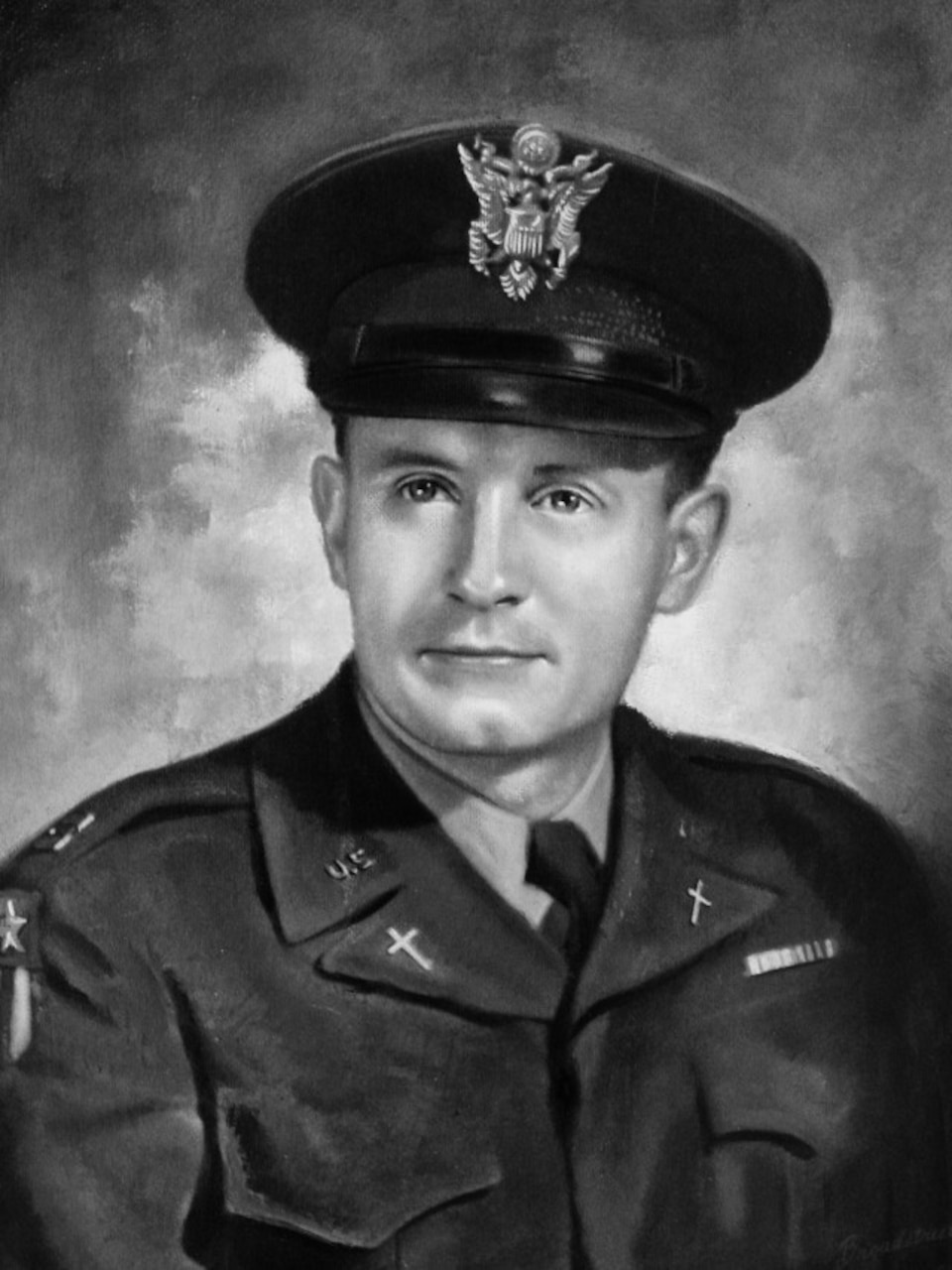 A man in a military uniform and cap poses for a photo.
