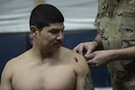 Staff Sgt. Anthony Mandt, 82nd Expeditionary Air Support Operations Squadron tactical air control party member, receives an acupuncture deep shoulder stimulation from Lt. Col. James Arnold, 386th Expeditionary Medical Group chief of medical staff, at Camp Buehring, Kuwait, March 12, 2019. Deep shoulder stimulation allows the body to perceive injury differently so that less pain is felt allowing the patient to have increased mobility and function. (U.S. Air Force Photo/Tech. Sgt. Robert Cloys)