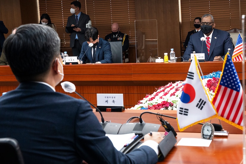 South Korean leaders sit across a table from their American counterparts.