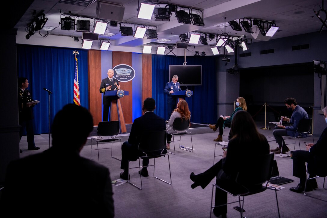 Adm. Craig Faller speaks with press members.