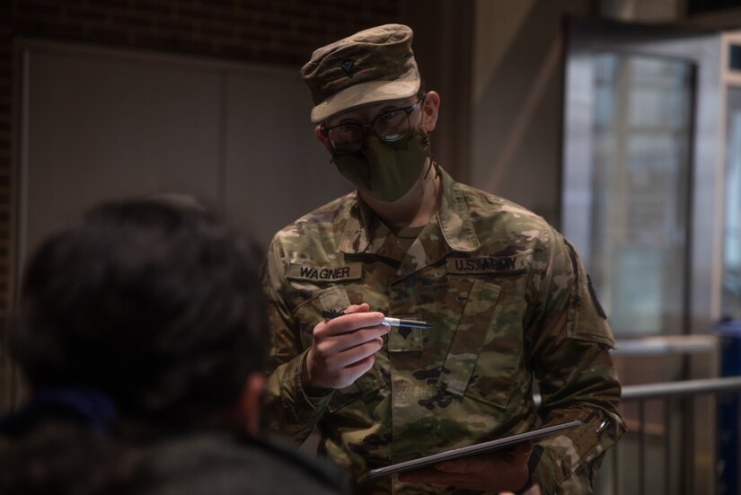 Spc. Grant Wagner, a native of Marysville, Pennsylvania, with the Pennsylvania National Guard, registers a community member for a COVID-19 vaccine at the state-run, federally-supported Center City Community Vaccination Center in the Pennsylvania Convention Center in Philadelphia on March 17, 2021.