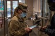 Airman 1st Class, Mackenzie Taylor, a native of Milton, Pennsylvania, with the Pennsylvania National Guard, registers a community member for a COVID-19 vaccine at the state-run, federally-supported Center City Community Vaccination Center in the Pennsylvania Convention Center in Philadelphia on March 17, 2021.