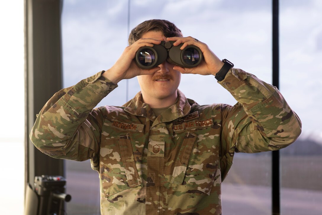 U.S. Master Sgt. Seth Norman, 420th Expeditionary Air Base Squadron air traffic tower chief control, deployed from the 48th Operations Support Squadron at Royal Air Force Lakenheath, inspects the flight line for incoming aircraft at RAF Fairford, England, March 15, 2021. U.S. forces in Europe remain committed to collective defense and cooperative security alongside European allies and partners. (U.S. Air Force photo by Senior Airman Jennifer Zima)