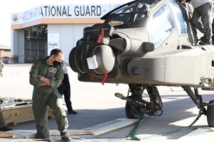 Members of the Arizona National Guard’s 161st Air Refueling Wing, the Royal Air Force, and The Boeing Company load an AH-64 Apache helicopter into a Royal Air Force C-17 Globemaster III, at the Goldwater Air National Guard Base in Phoenix, Arizona Jan. 21, 2021. The 161st was contacted by the U.S. Army’s Apache foreign military sales program office to help load the attack helicopters on C-17 aircraft for shipment to the UK, due to its secure ramp space for the project, and qualified air transportation specialists who can process complex air cargo ensuring safety of flight during air transport.  (U.S. Army National Guard photo by Spc. Thurman Snyder)