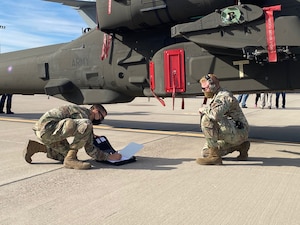 Staff Sgt. Chaz Bruno and Staff Sgt. Joe Franzen, air cargo specialists with the 161st Logistics Readiness Squadron, conduct a pre-flight inspection of an AH-64 Apache helicopter at the Goldwater Air National Guard Base in Phoenix, Arizona on Jan. 21, 2021. The 161st was contacted by the U.S. Army’s Apache foreign military sales program office to help load the attack helicopters on C-17 aircraft for shipment to the UK, due to its secure ramp space for the project, and qualified air transportation specialists who can process complex air cargo ensuring safety of flight during air transport.  (U.S. Air National Guard photo by 2nd Lt. Wes Parrell)