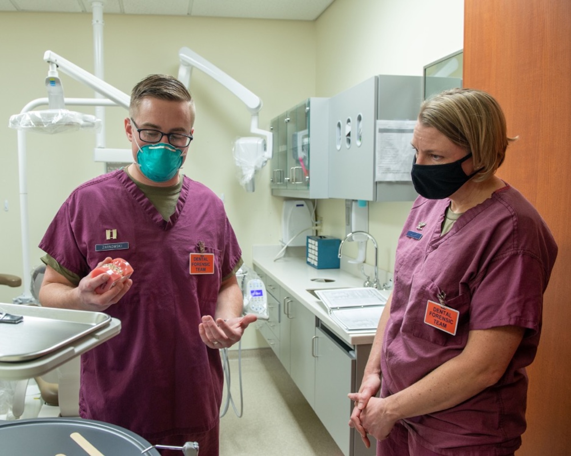 U.S. Air Force Capt. Ryan Zarnowski, left, a general dentist assigned to the 673d Dental Squadron, shows typodont model teeth to U.S. Air Force Col. Kirsten Aguilar, Joint Base Elmendorf-Richardson and 673d Air Base Wing commander, at JBER, Alaska, March 2, 2021.