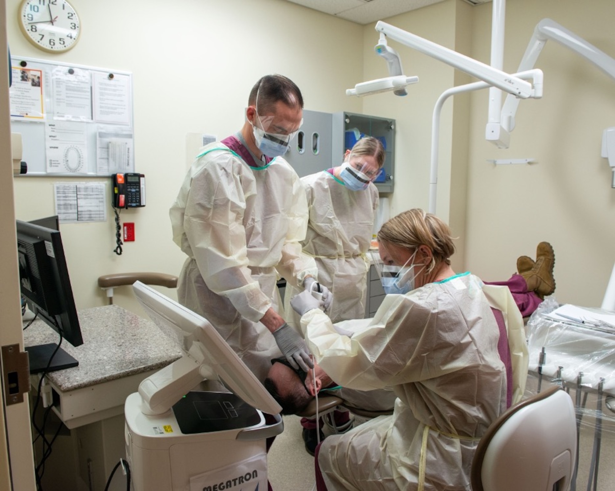 U.S. Air Force Senior Airman Regan Bassett, left, a dental technician assigned to the 673d Dental Squadron, guides a dental scan on U.S. Air Force Chief Master Sgt. Lee Mills, Joint Base Elmendorf-Richardson and 673d Air Base Wing command chief during a 673d Dental Squadron immersion tour at Joint Base Elmendorf-Richardson, Alaska, March 2, 2021.