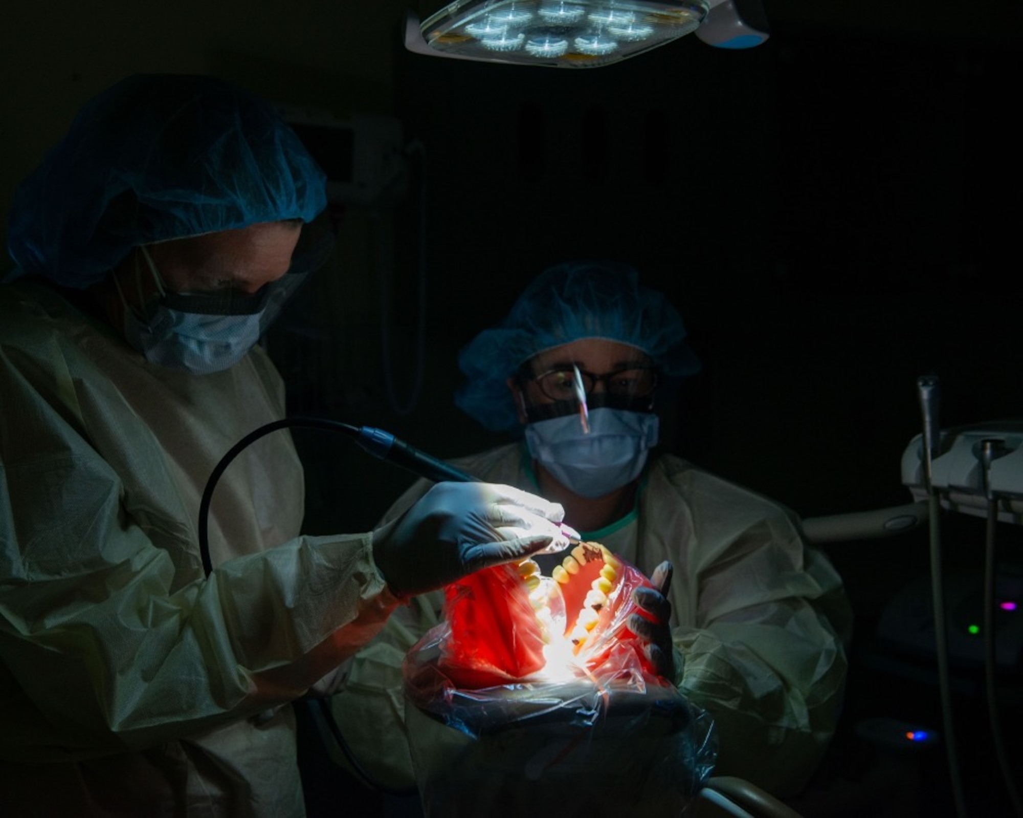 U.S. Air Force Master Sgt. Caludia Pedroza, right, a dental hygienist assigned to the 673d Dental Squadron, leads a teeth cleaning demonstration with U.S. Air Force Col. Kirsten Aguilar, Joint Base Elmendorf-Richardson and 673d Air Base Wing commander, at JBER, Alaska, March 2, 2021.