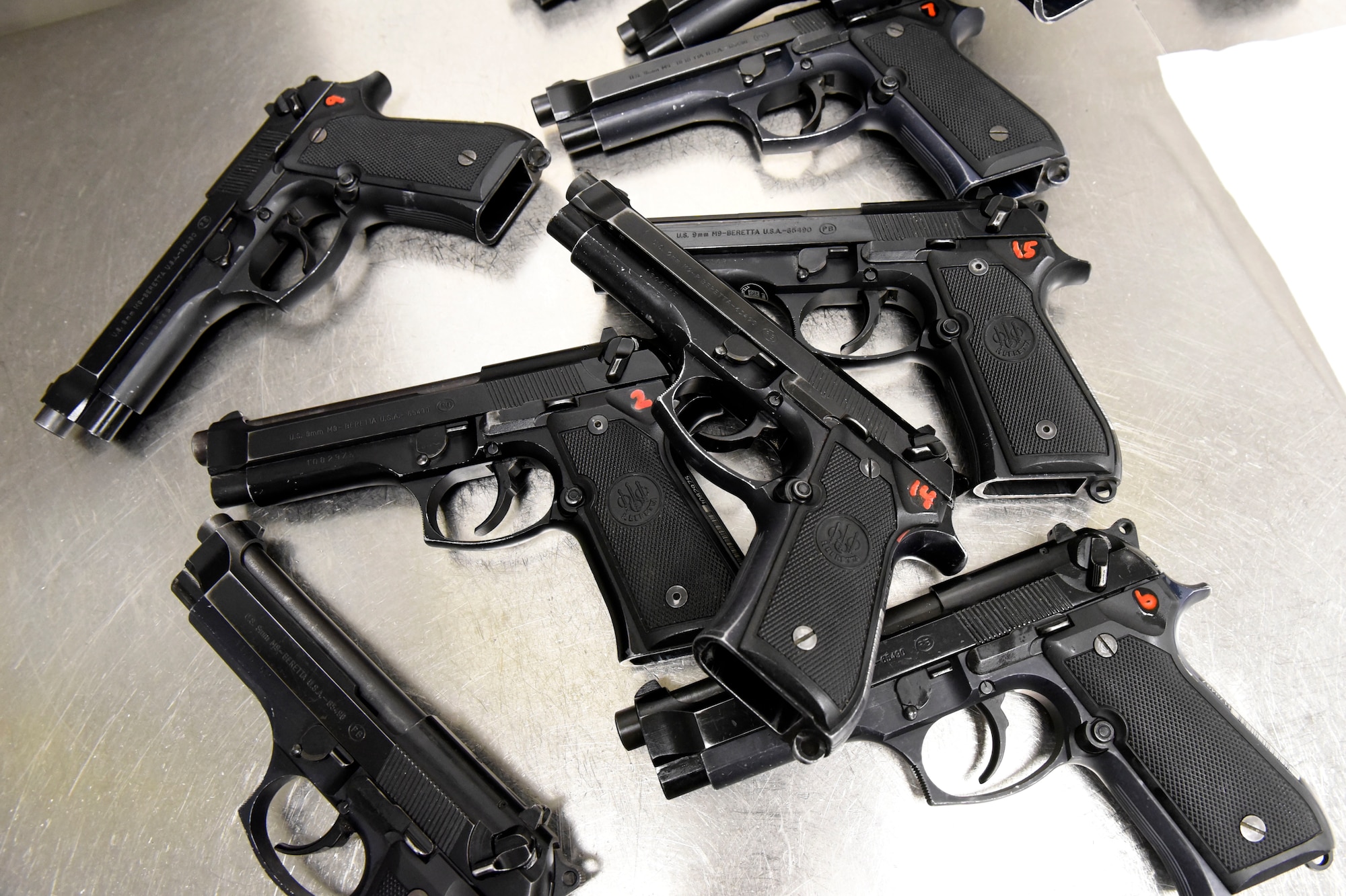 Freshly cleaned M9 pistols sit in the weapons cleaning room inside the 88th Security Forces Squadron Combat Arms firing range at Wright-Patterson Air Force Base, Ohio on Feb. 18, 2021. Weapons qualification is part of the readiness standards for the 88th Air Base Wing. (U.S. Air Force photo by Ty Greenlees)