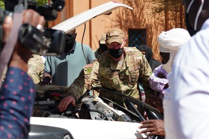 U.S. Air Force Staff Sgt. Jeffrey Urquhart, 724th Logistics Readiness Flight vehicle maintenance technician, briefs repairs that were made on an unserviceable ambulance to medical staff and media at the District Sanitaire Commune d'Agadez clinic in Agadez, Niger, Oct. 30, 2020.
