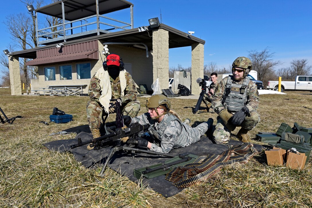 Air Force combat arms instructors with the 88th Security Forces Squadron from Wright-Patterson Air Force Base, Ohio, assemble an M240B machine gun on a shooting range at Camp Atterbury in Edinburgh, Indiana, on Feb. 25, 2021. The combat arms instructors, travel to Camp Atterbury multiple times each year for readiness and qualification training with deployers on machine guns and grenade launchers. (U.S. Air Force photo by Ty Greenlees)