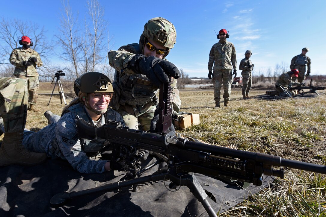 Air Force Senior Airman Aurielle Marvin, an 88th Security Forces Squadron patrolman, and Airman 1st Class Michael Lawhead, an 88th SFS alarm monitor, work together to operate the M240B machine gun at Camp Atterbury in Edinburgh, Indiana, on Feb. 25, 2021. Members of the 88th SFS, travel to Camp Atterbury multiple times each year for readiness and qualification training with deployers on machine guns and grenade launchers. (U.S. Air Force photo by Ty Greenlees)
