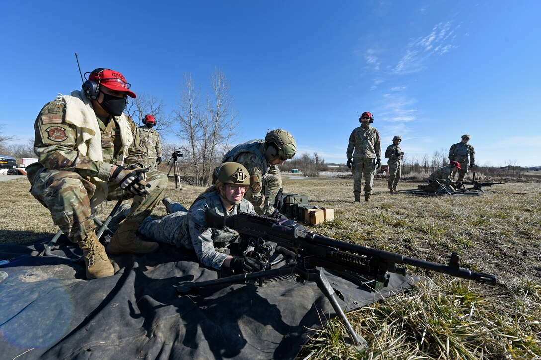 Air Force combat arms instructors with the 88th Security Forces Squadron watch as Airmen prepare to fire an M240B machine gun at Camp Atterbury in Edinburgh, Indiana, on Feb. 25, 2021. The combat arms instructors, from Wright-Patterson Air Force Base, Ohio, travel to Camp Atterbury multiple times each year for readiness and qualification training with deployers on machine guns and grenade launchers. (U.S. Air Force photo by Ty Greenlees)