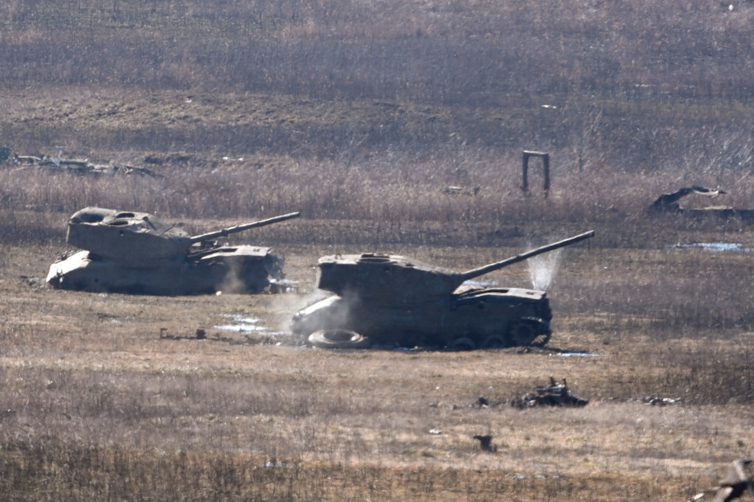 Machine gun bullets fired by members of the 88th Security Forces Squadron, from Wright-Patterson Air Force Base, Ohio, hit old tanks and the surrounding ground at Camp Atterbury in Edinburgh, Indiana, on Feb. 25, 2021. Members of the 88th SFS, travel to Camp Atterbury multiple times each year for readiness and qualification training with deployers on machine guns and grenade launchers. (U.S. Air Force photo by Ty Greenlees)