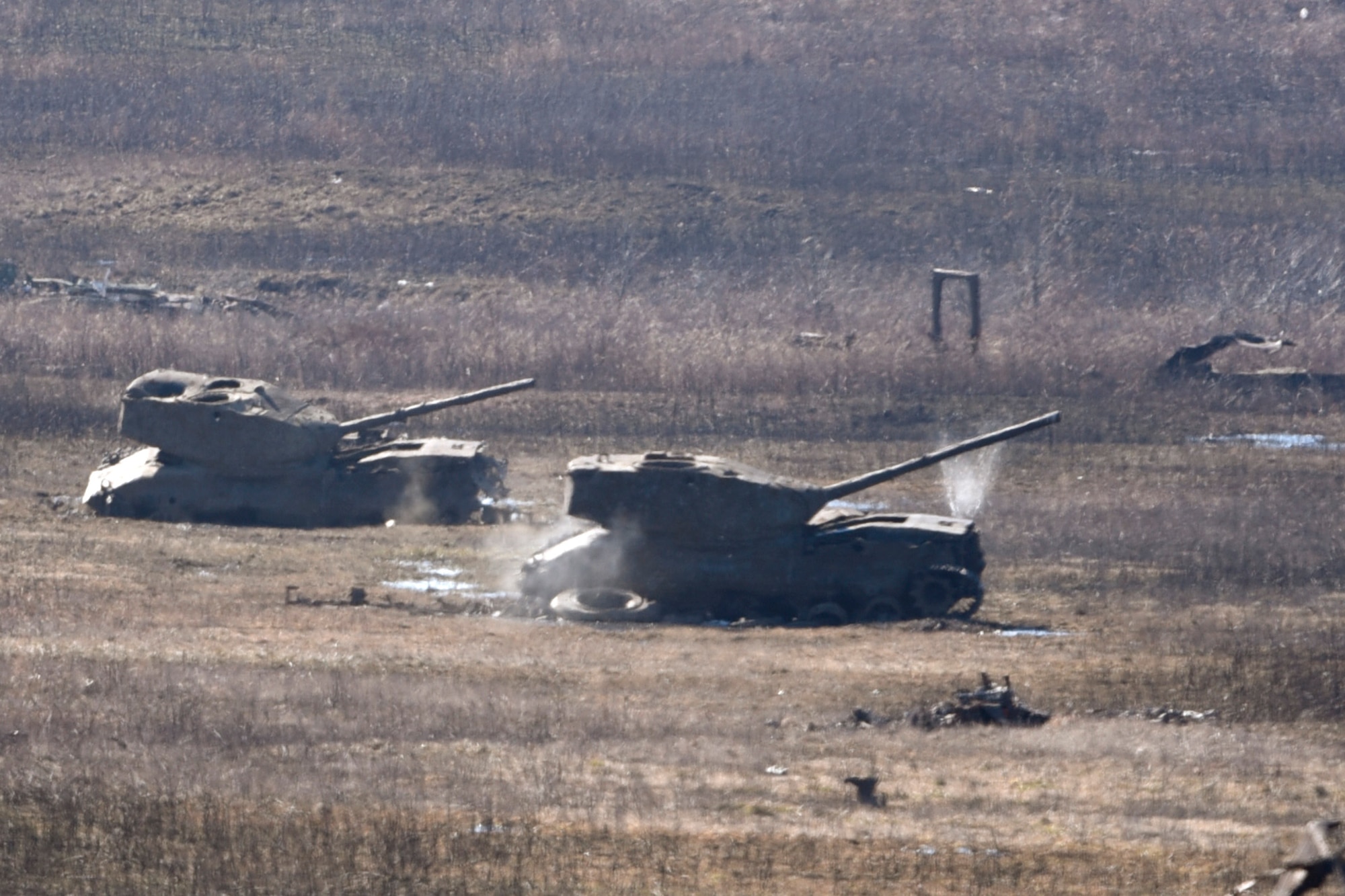 Machine gun bullets fired by members of the 88th Security Forces Squadron, from Wright-Patterson Air Force Base, Ohio, hit old tanks and the surrounding ground at Camp Atterbury in Edinburgh, Indiana, on Feb. 25, 2021. Members of the 88th SFS, travel to Camp Atterbury multiple times each year for readiness and qualification training with deployers on machine guns and grenade launchers. (U.S. Air Force photo by Ty Greenlees)