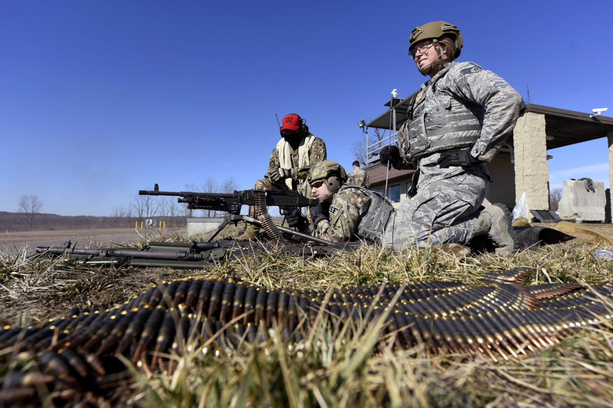Air Force Airman 1st Class Michael Lawhead, center, an 88th Security Forces Squadron alarm monitor, fires an M240 machine gun with Senior Airman Aurielle Marvin, an 88th SFS patrolman, under the direction of Senior Airman Jerome Fogg, an 88th SFS combat arms instructor, left, at Camp Atterbury in Edinburgh, Indiana, on Feb. 25, 2021. The combat arms instructors, from Wright-Patterson Air Force Base, Ohio, travel to Camp Atterbury multiple times each year for readiness and qualification training with deployers on machine guns and grenade launchers. (U.S. Air Force photo by Ty Greenlees)