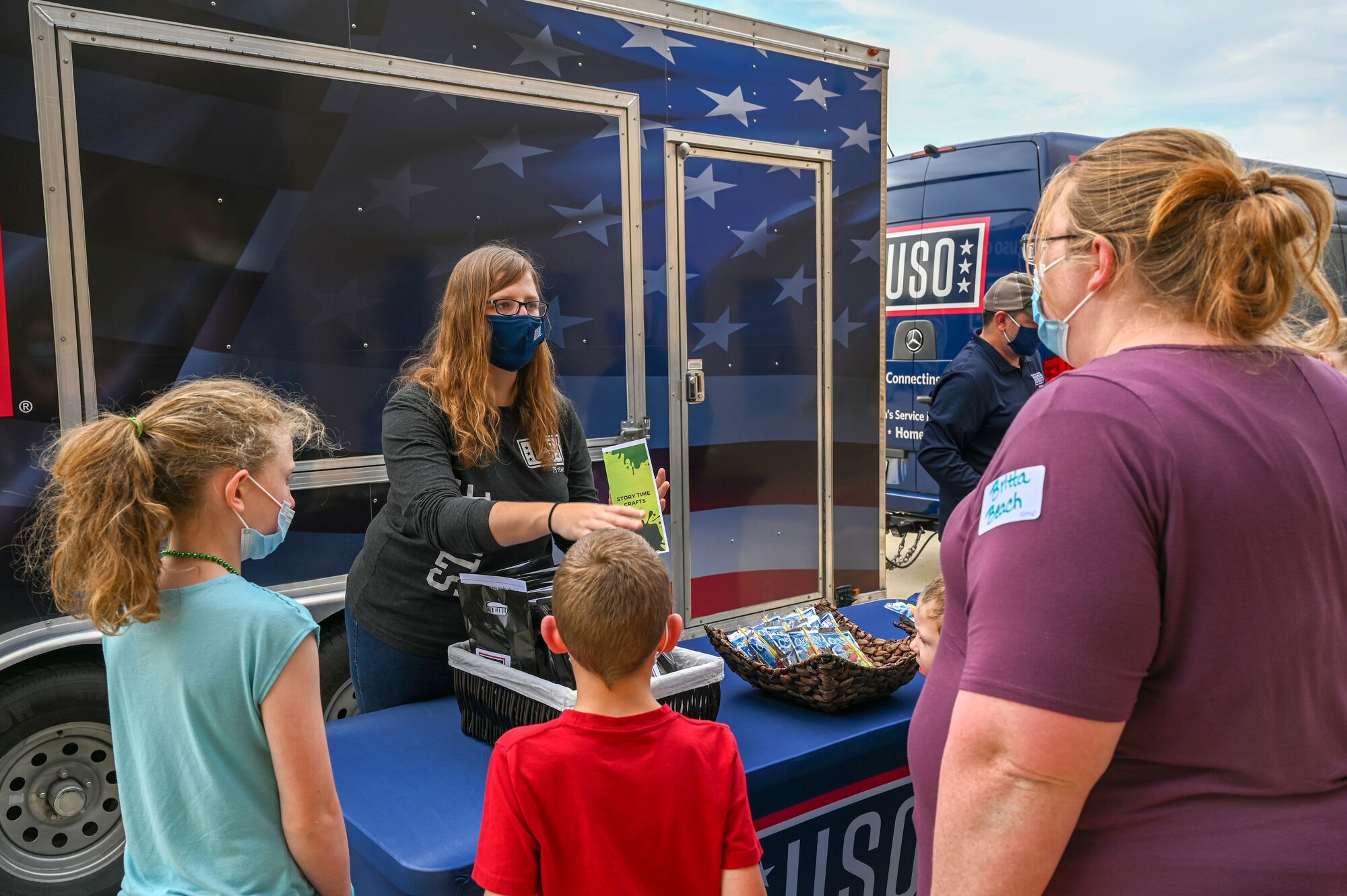 a woman and kids at an event