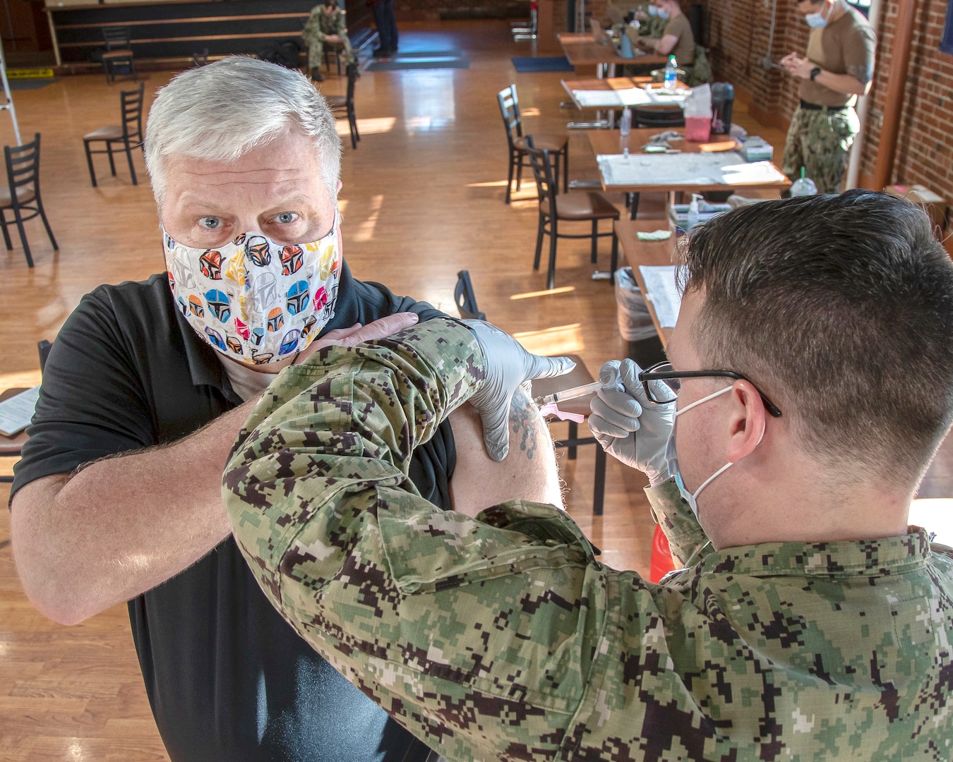 Dan Bell receives the first-of-two Moderna COVID-19 vaccine shots Feb. 10, 2021, in the former Samuel Adams Brewhouse on Naval Base Kitsap-Bremerton, in what is expected to be a phased employee vaccination process.