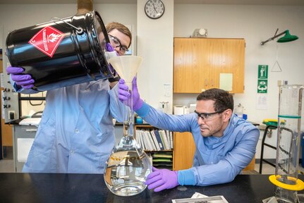 Anthony Painter, left, and Deniz Ferrin, both chemists, Code 130, Quality Assurance Office, make hand sanitizer March 20, 2020, in Building 59 at Puget Sound Naval Shipyard & Intermediate Maintenance Facility in Bremerton, Washington.