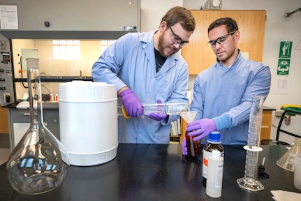Anthony Painter, left, and Deniz Ferrin, both chemists, Code 130, Quality Assurance Office, make hand sanitizer March 20, 2020, in Building 59 at Puget Sound Naval Shipyard & Intermediate Maintenance Facility in Bremerton, Washington.