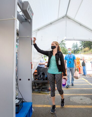 Employees complete temperature screening inside Farragut Gate at Puget Sound Naval Shipyard & Intermediate Maintenance Facility, in Bremerton, Wash.