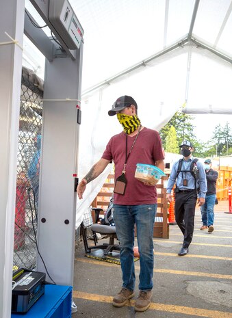 Employees complete temperature screening inside Farragut Gate at Puget Sound Naval Shipyard & Intermediate Maintenance Facility, in Bremerton, Wash.