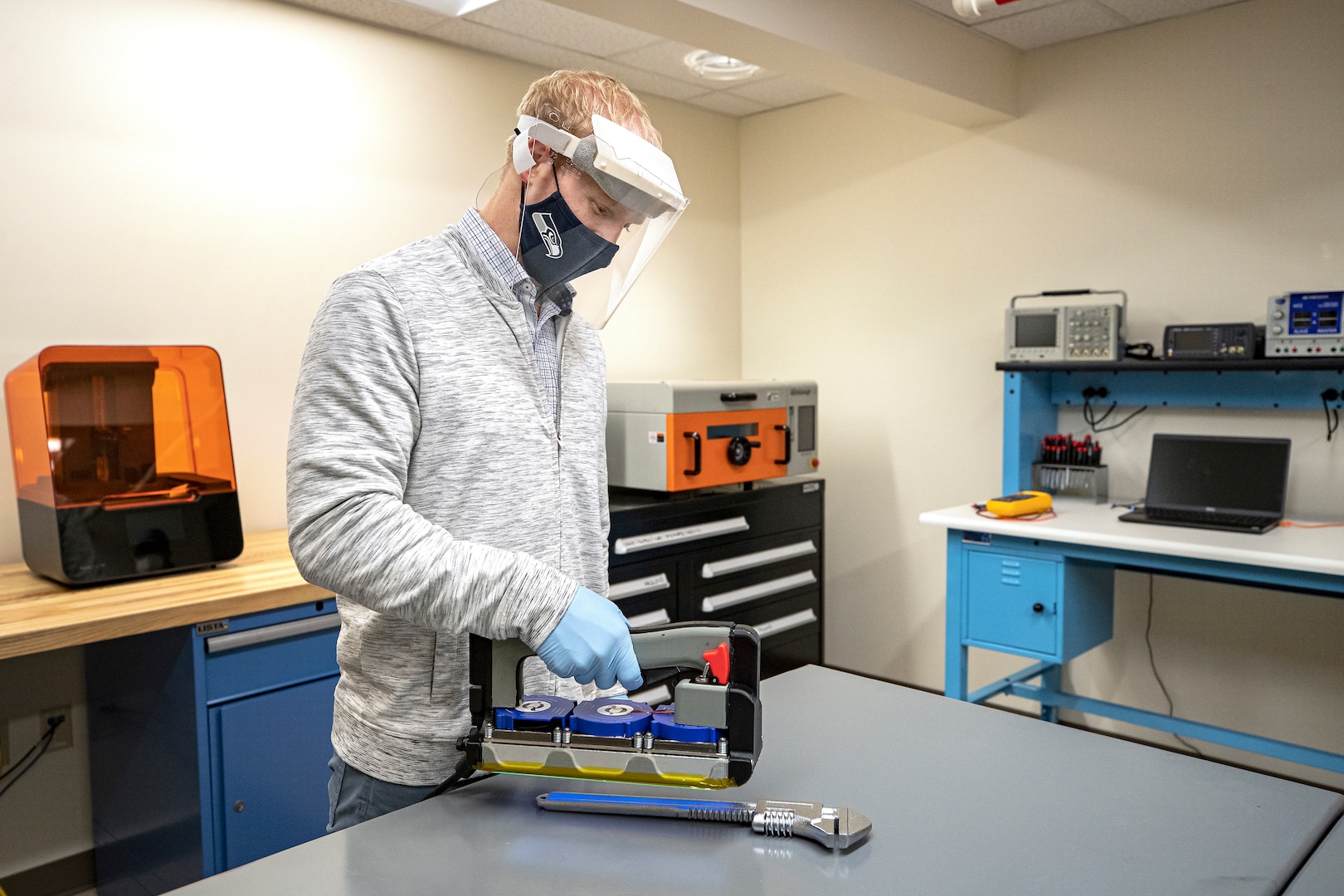 Branden Doyle, Code 2301 nuclear innovation program manager, sanitizes a crescent wrench Nov. 13, 2020, using a UVC-LED Handheld Sanitizer designed by employees in the PSNS Innovation Lab in Building 435 at Puget Sound Naval Shipyard & Intermediate Maintenance Facility in Bremerton, Washington.