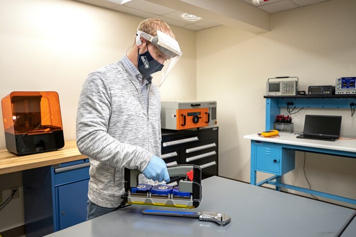 Branden Doyle, Code 2301 nuclear innovation program manager, sanitizes a crescent wrench Nov. 13, 2020, using a UVC-LED Handheld Sanitizer designed by employees in the PSNS Innovation Lab in Building 435 at Puget Sound Naval Shipyard & Intermediate Maintenance Facility in Bremerton, Washington.