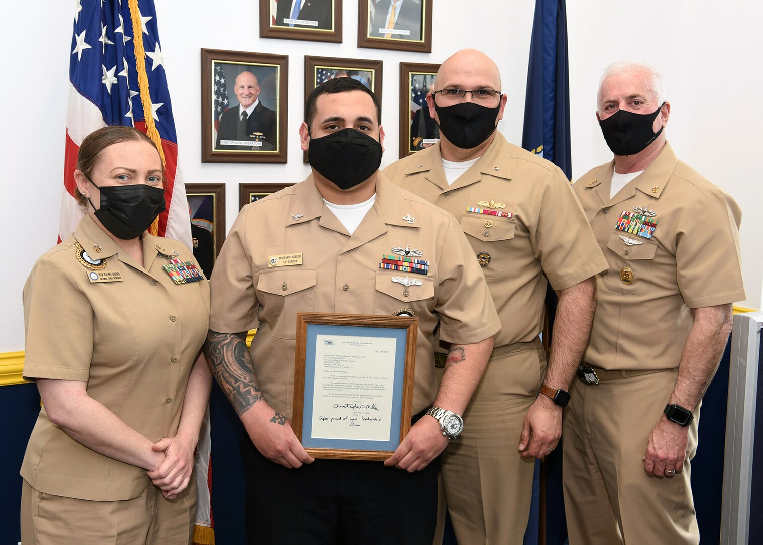 Petty Officer 2nd Class Brandon Rodriguez, a talent scout assigned to Navy Talent Onboarding Center Alamo City, was presented with a thank you letter from the Secretary of Defense by Rear Adm. Dennis Velez, commander, Navy Recruiting Command at Navy Recruiting Station Southeast San Antonio March 9. Rodriguez was one of two Sailors recognized for their actions on Nov. 5, 2020, for providing vital medical care to a gunshot victim near one of their assigned high schools. Joining Velez at the presentation were NRC Command Master Chief Rick Moreyra and National Chief Recruiter, Master Chief Navy Counselor Heather Charara.