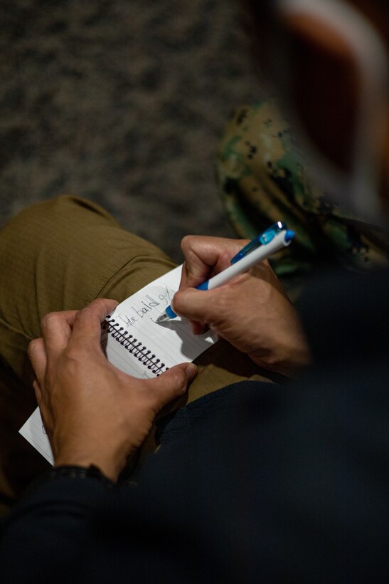 An Okinawa resident writes down English words during the English discussion class at the chapel on Marine Corps Air Station Futenma (MCAS), Okinawa, Japan, March 16, 2021. The Futenma Chapel English discussion provides U.S. Marines and Okinawa residents with an opportunity to learn each other's languages and share their cultures. The discussion is held every Tuesday at the MCAS Futenma Chapel at 6:30 p.m. (U.S. Marine Corps photo by Cpl. Terry Wong)
