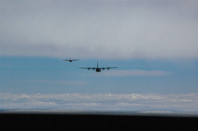 Two C-130s fly in formation