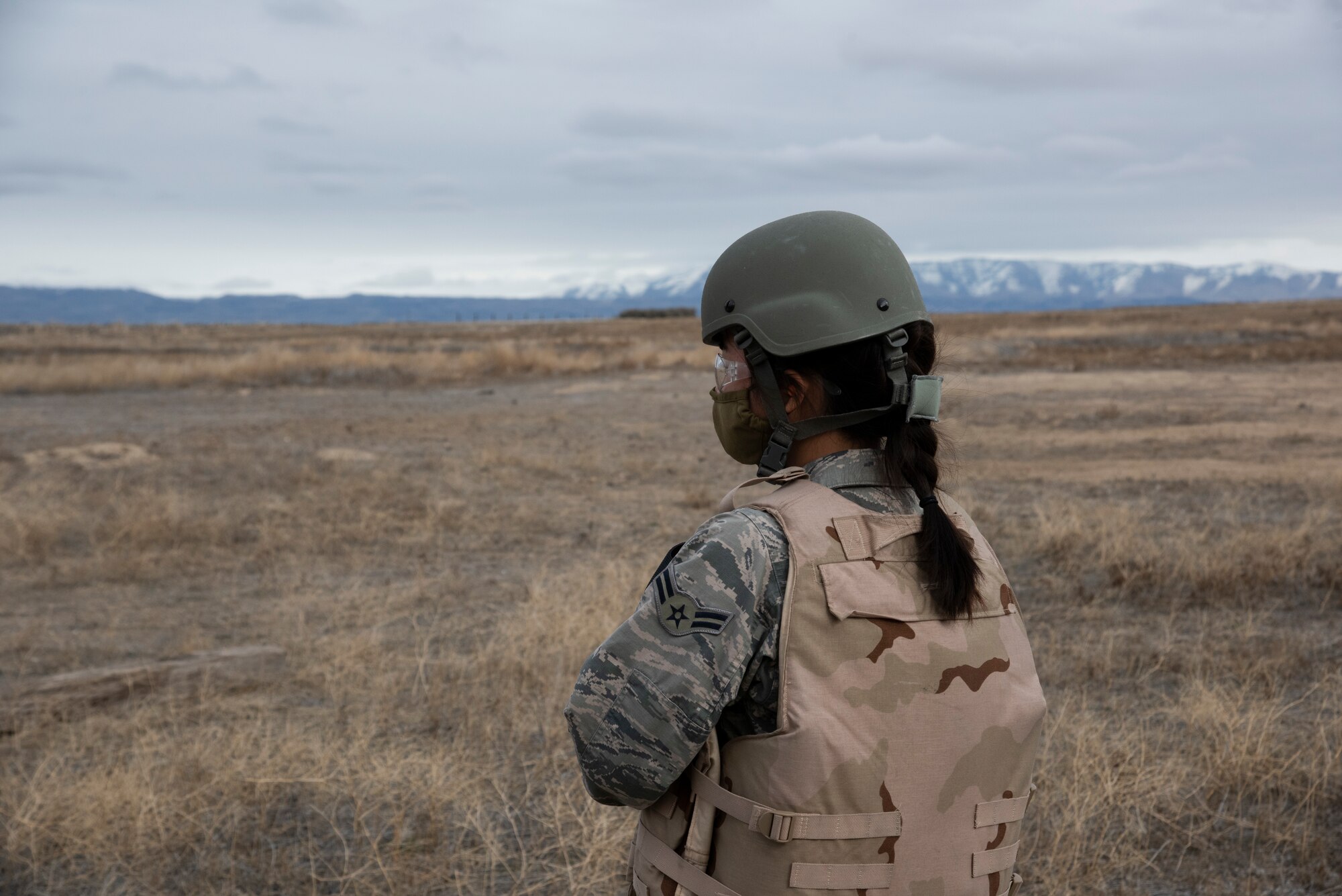 A female Airmen stands providing security for a tactical training exercise.