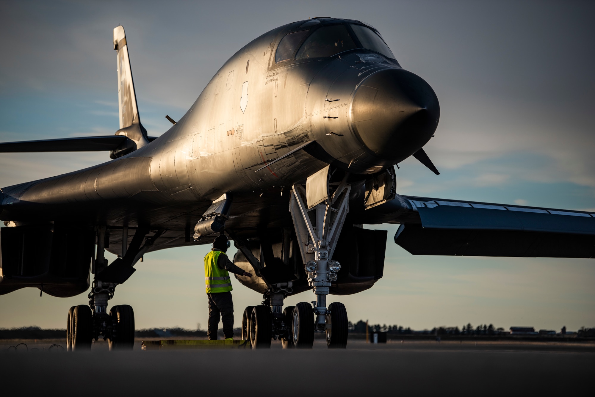 A crew chief assigned to the 9th Expeditionary Bomb Squadron marshals a B-1B Lancer at Ørland Air Force Station, Norway, March 14, 2021. Conducting bomber training missions allows aircrew to maintain a high state of readiness and proficiency, and validate the U.S. Air Force’s always-ready global strike capability. (U.S. Air Force photo by Airman 1st Class Colin Hollowell)
