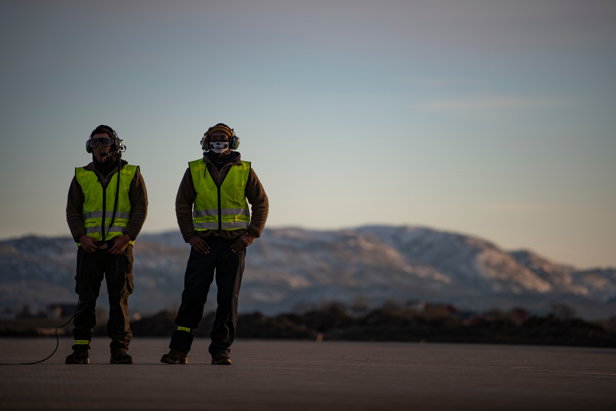 Two crew chiefs assigned to the 9th Expeditionary Bomb Squadron wait to conduct a hot-pit refuelling of a B-1B Lancer at Ørland Air Force Station, Norway, March 14, 2021. Four B-1s and approximately 200 Airmen deployed with the 9th EBS in support of a Bomber Task Force Europe deployment. (U.S. Air Force photo by Airman 1st Class Colin Hollowell)