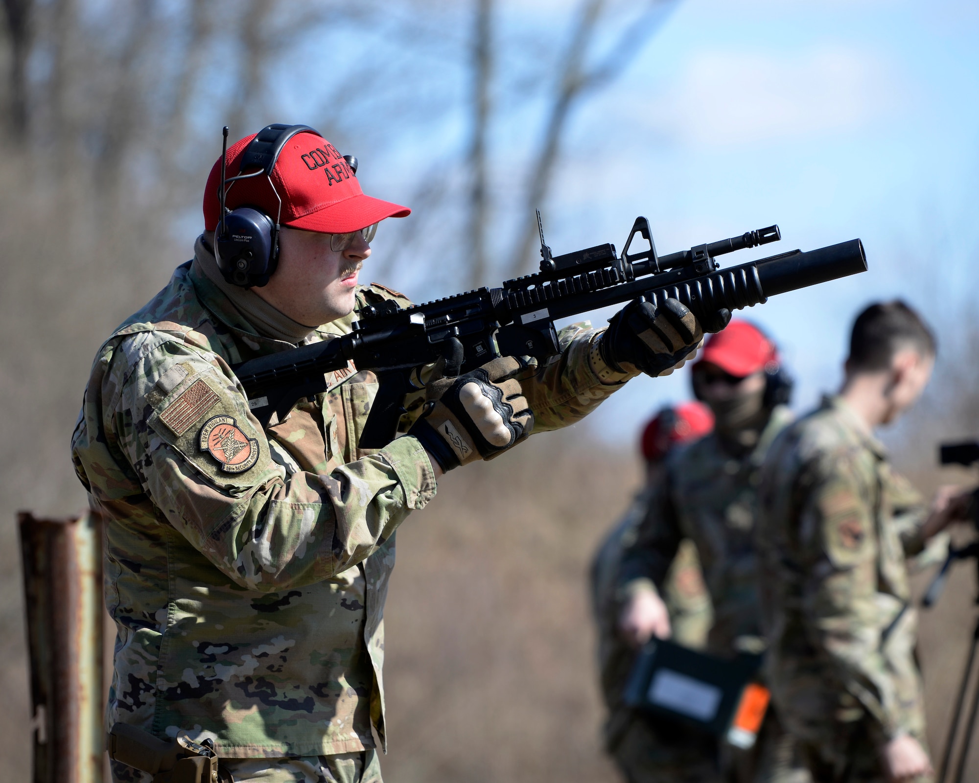 Air Force Senior Airman Clayton Nyp, an 88th Security Forces Squadron combat arms instructor, fires an M203 grenade launcher at Camp Atterbury in Edinburgh, Indiana, on Feb. 25, 2021. The combat arms instructors, from Wright-Patterson Air Force Base, Ohio, travel to Camp Atterbury multiple times each year for readiness and qualification training with deployers on machine guns and grenade launchers. (U.S. Air Force photo by Ty Greenlees)