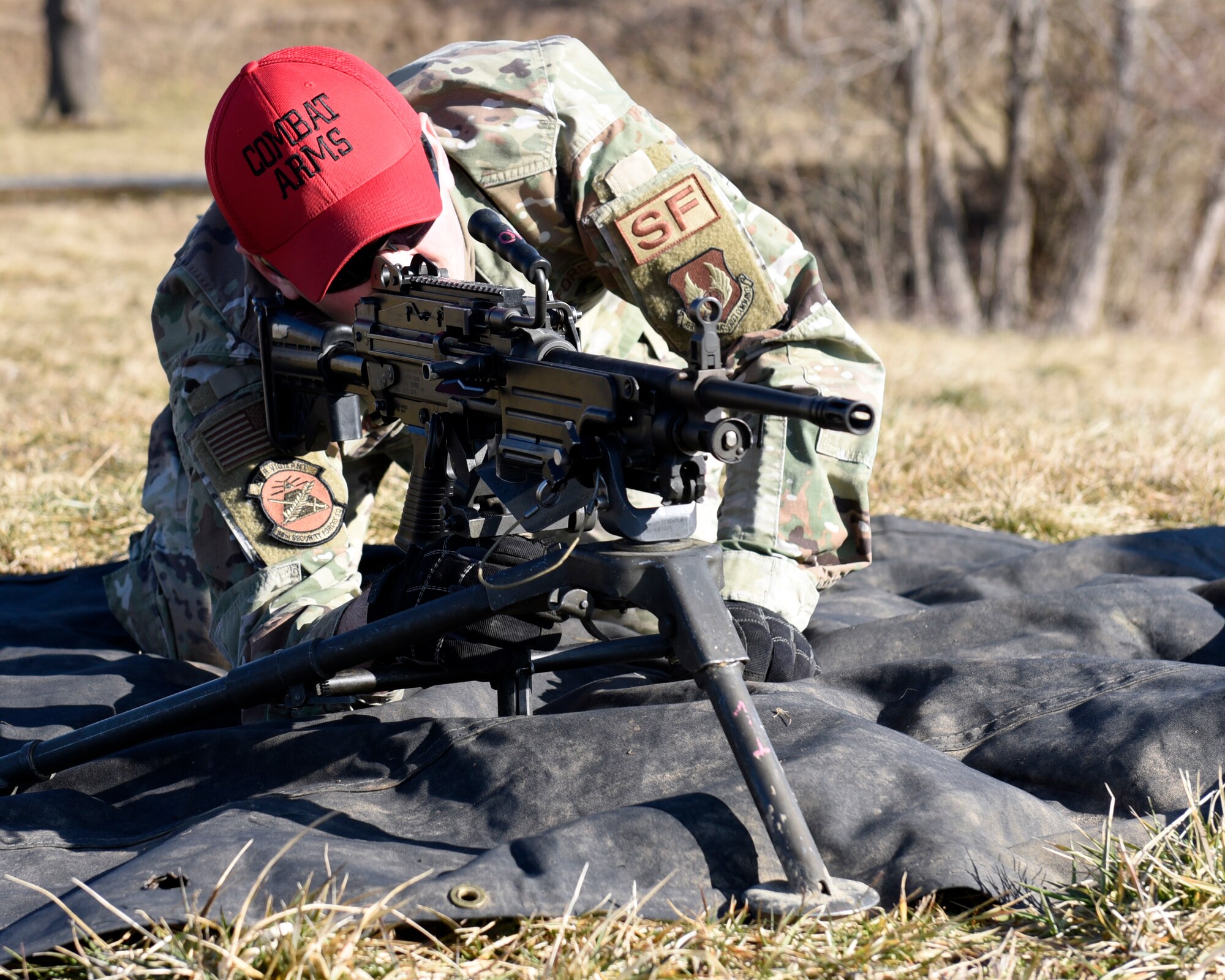 Air Force Staff Sgt. Sawyer McIntyre, an 88th Security Forces Squadron combat arms instructor, sights an M240B machine gun at Camp Atterbury in Edinburgh, Indiana, on Feb. 25, 2021. 88th SFS combat arms instructors, from Wright-Patterson Air Force Base, Ohio, travel to Camp Atterbury multiple times each year for readiness and qualification training with deployers on machine guns and grenade launchers. (U.S. Air Force photo by Ty Greenlees)